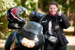 GettyImages 171147980 1 300x200 Woman posing happily next to her motorcycle